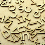Scattered wooden letters on a beige background